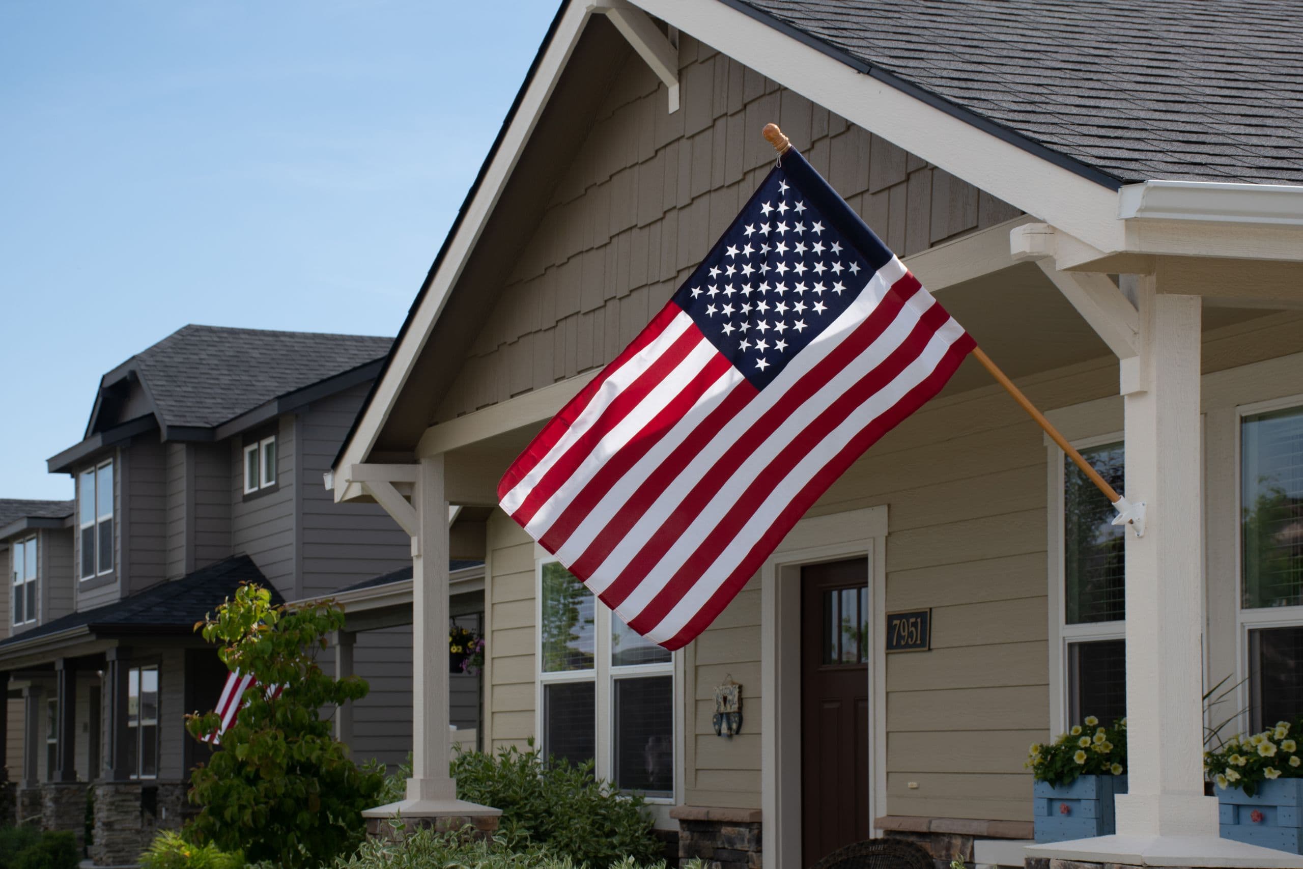 A covered front porch under a clear blue sky
